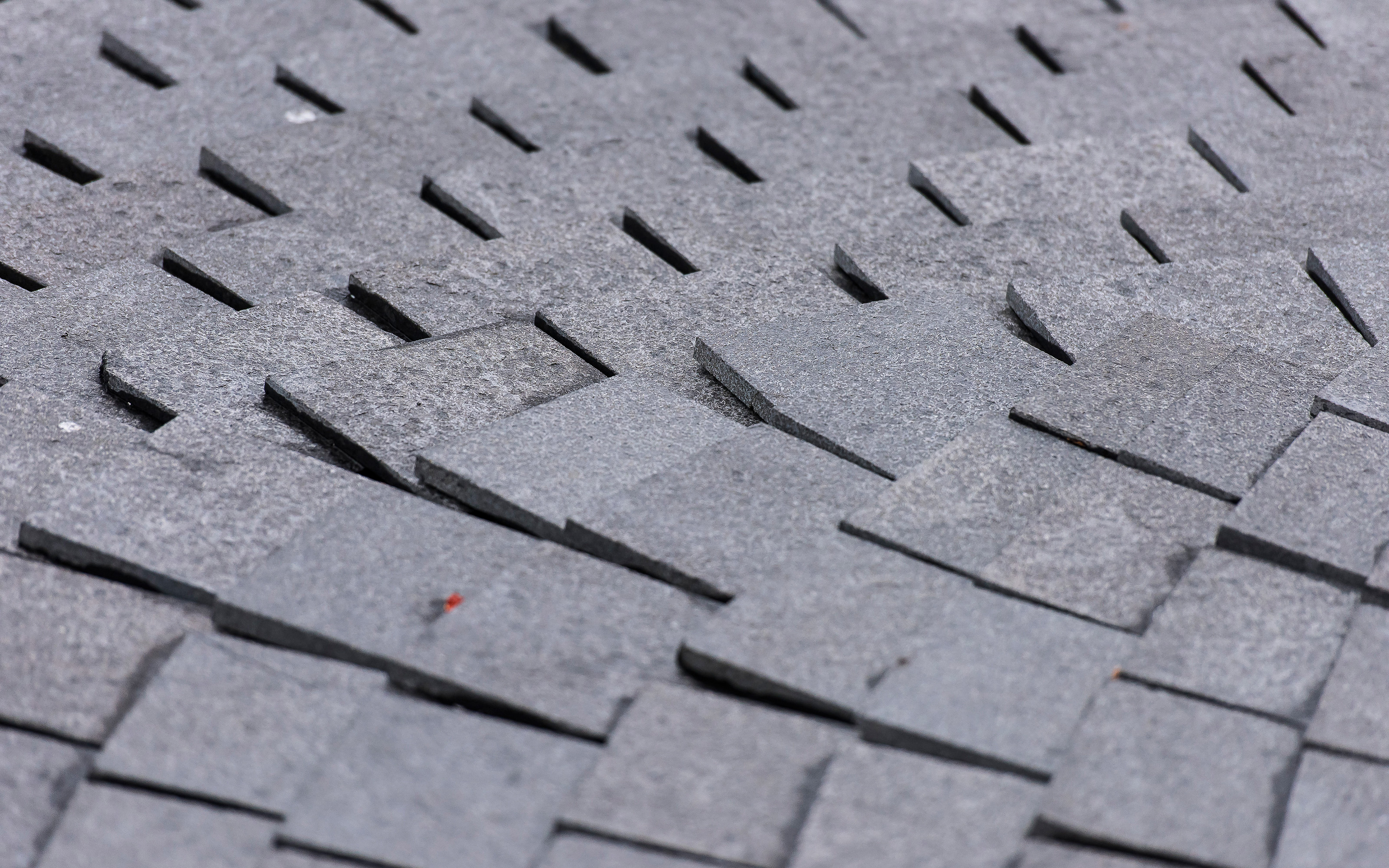 Square-shaped slabs form the walkways on the roof surface. Walkways with quare-shaped slabs